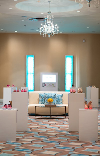 The networking lounge showcased a silent auction of pink shoes sponsored by QVC Presents FFANY Shoes On Sale, with proceeds benefiting breast cancer research. Ronen Rental supplied the sofas and pillows and Lavish Event Rental provided wooden chairs.