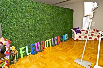 Smilebooth provided a photo station with a grassy step-and-repeat and props including a flowery picture frame.