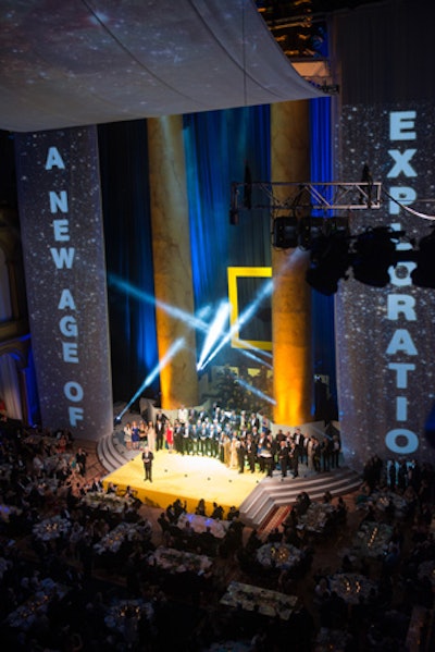 For the program’s finale, the 80-foot screen projecting high-definition National Geographic videos and still images flew up in a four-second reverse Kabuki drop, revealing the Society’s Explorers-in-Residence, photographers, 2013 Emerging Explorers, the Washington Symphonic brass, and six gala awardees: explorer and filmmaker James Cameron, National Geographic Bee moderator Alex Trebek, oceanographer Sylvia Earle, scientist and author Edward O. Wilson, philanthropist Howard G. Buffett, and BASE jumper Felix Baumgartner.