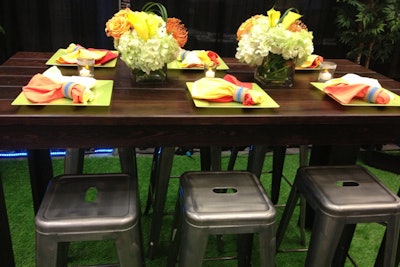 AFR Event Furnishings showed off its new 'Marcus' stools at a display that combined an industrial look with natural, colorful details at its 'Memphis' dining table.