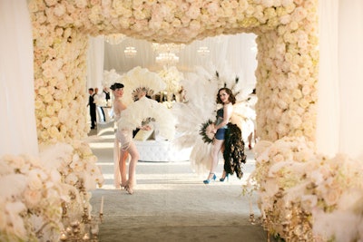 Guests entered through a tented hallway lined with candelabras and rose petals before emerging into the main space, where an array of entertainment offerings packed the party, including vintage burlesque and cabaret dancers.