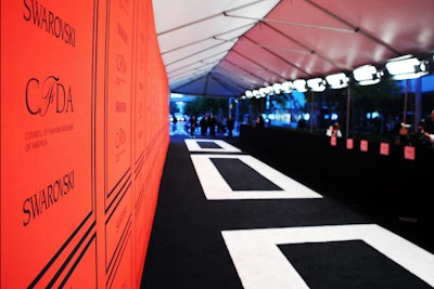 'We wanted to keep a unified design aesthetic,' said KCD president and partner Julie Mannion, who oversaw the production of the awards. So from the invitation to the red carpet, a black-and-white color scheme, with a red accent, was devised to reinforce the signature color of the C.F.D.A. and what is an overarching color trend in the spring 2013 collections. The 90-foot-long step-and-repeat, designed by Laird & Partners, echoed the interior design with black molding and logos. The black carpet with white inlay, designed by KCD, measured 20 by 120 feet.