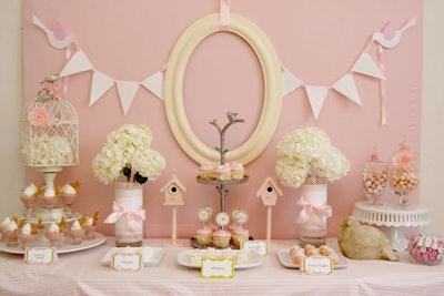 One of Biggs's clients recently asked her to design a baby shower with a 'pink birdie theme.' Decked with birdhouses and an elegant birdcage, the sweets table had a pallet of soft pinks. It held raspberry mousse with fresh whipped cream, petit fours, meringues, cupcakes, chocolate brownie truffles, and apothecary jars filled with rosy candies. Biggs used hair clips and hair bands to decorate the birdcage and candy jars.