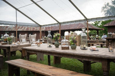 As the exclusive design partner for the evening, online event decor and accessory company Pressed Cotton provided the party’s rustic-chic details. Wooden picnic tables were lined with Kraft paper runners printed with illustrations of vintage silverware, and glass cloches housed homemade honey, jams, and pickled veggies.