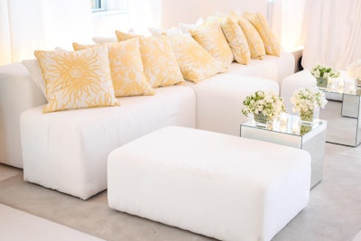In contrast to the stormy skies outside, summery indoor lounge areas were decorated to match the iconic buttery yellow color of the moisturizer. The modular white lounge seating was provided by Taylor Creative Inc.