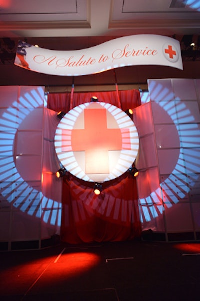 A banner and giant red cross were part of the event staging and changed appearance with lighting patterns.
