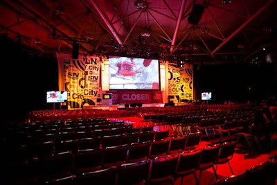 The setup included a large stage with a 37- by 18-foot screen and silk banners.