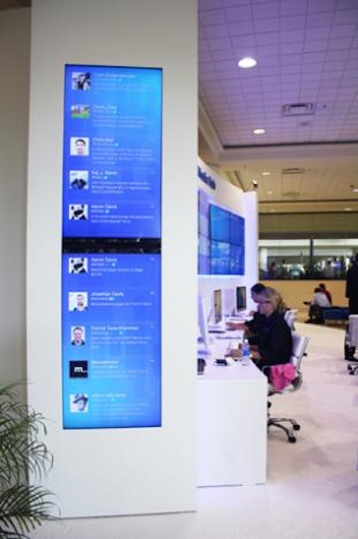 A live feed of Twitter comments about the event scrolled on vertical monitors on either side of the main display.
