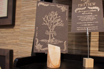 A rustic invitation printed by AR-EN Party Printers has a letter-pressed wood grain pattern.