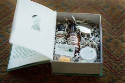 Nodding to the Prohibition theme, the gift bag contained a box designed to look like a book, which opened up to reveal a cocktail-making kit. The items inside included a miniature bottle of bitters, a jar of bourbon-soaked cherries, a branded muddler, and a tiny cocktail shaker.