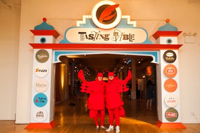 Tasting Table's planning team tapped event designers We Came in Peace to create a vintage Coney Island boardwalk atmosphere. A fabricated entrance arch displayed sponsor logos and a lobster claw surrounded by marquee lights. Staffers dressed as lobsters roamed the crowd.