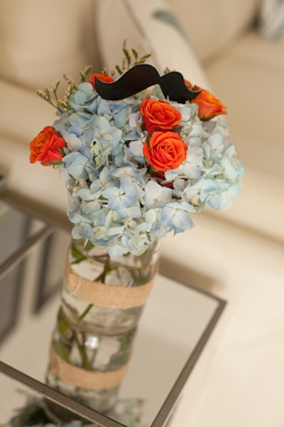 The arrangements of blue hydrangeas and orange spray roses also held paper mustaches. 'When you’re throwing a mustache bash, it’s really difficult to not slap a mustache on everything in the house that doesn’t move,' Biggs said. 'I did it anyway ... even the flowers got 'stached.' The flowers themselves were from Buds Etc. in Melbourne, Florida.