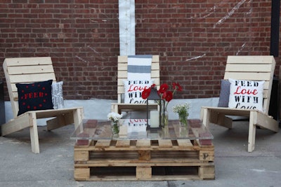 A lounge area included chairs and a coffee table crafted from wood pallets. Pillows and blankets from the Feed U.S.A. collection completed the look.