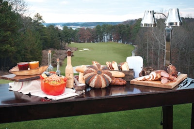 Outdoor break, including a carving board, international cheeses and breads, and paella, by Lake Lanier Islands Resort in Buford, Georgia