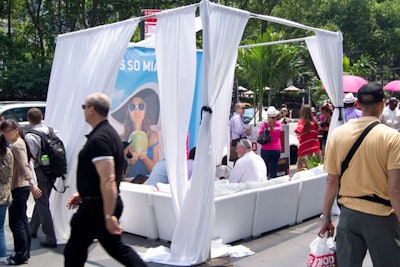 The public promotion had a cabana for V.I.P. guests that featured an all-white couch and colorful pillows with 'Miami' written on them. A DJ was stationed nearby to provide music.