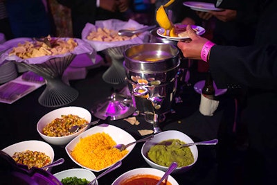 The Mexico tasting station held a make-your-own nachos and tostadas bar with toppings including seasoned chicken, beans, cheese, sour cream, guacamole, and salsa.