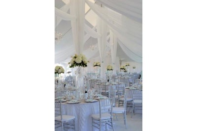 Tent ceiling draping with hydrangea centerpieces on glass