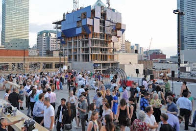 The event took place on the rooftop of a parking garage, where surrounding cranes and buildings under construction served as a visual reminder of the city's current condo boom.