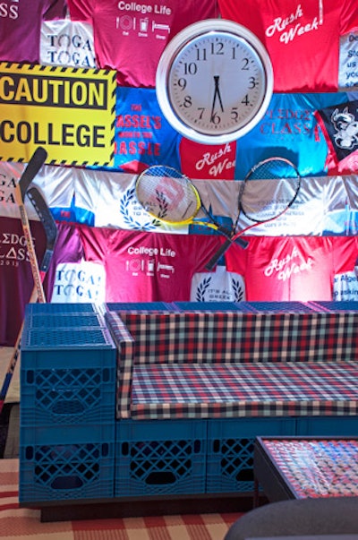 Dorm-style furniture included milk crates upholstered with plaid cushions.The back walls were made of T-shirts with printed sayings and were decked with other frat-house-style props.