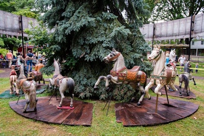 Event organizers, faced with a plethora of vintage props that were originally intended to be housed in a permanent museum, erected museum-like installations throughout the outdoor venue. Guests can admire, touch and, take photos with a display of period carousel horses (pictured).