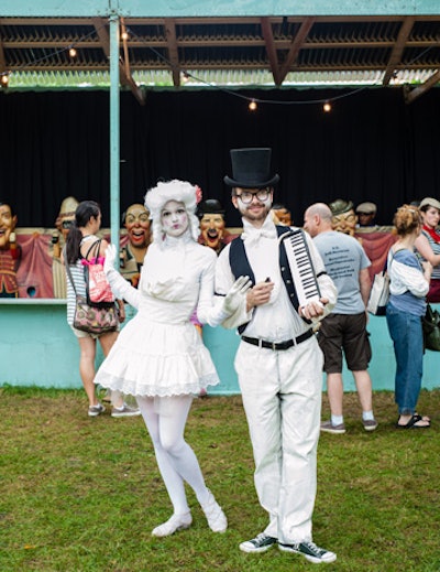 A bevy of carnival sideshow characters—many of them actors or models from the Brooklyn Academy of Music—roam the carnival grounds, posing for photos and entertaining visitors with music and live acts.