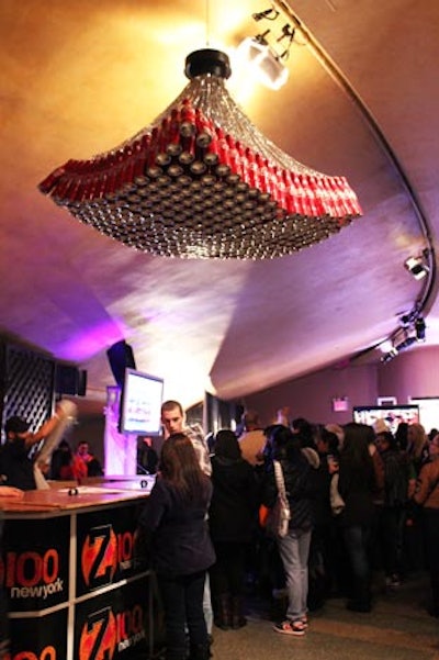 For Z100's All Access Lounge, a preshow festival for the 2011 Jingle Ball concert, presenting sponsor Coca-Cola incorporated subtle branding into the Hammerstein Ballroom's decor with a hanging installation of Coke cans.