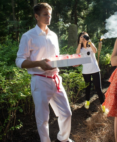 Stationed along a path lined with tiki torches, the waitstaff wore all-white uniforms with red rope belts and offered guests cherry-garnished Bacardi cocktails.