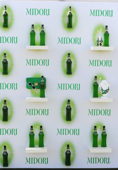 In June, jewelry company Stella & Dot teamed up with liquor brand Midori to host a happy hour event on the rooftop of the London West Hollywood. Small shelves were built into the press wall in order to display emerald green accessories from the line alongside the green-colored booze.
