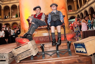 Boys dressed in old-fashioned attire posed for pictures at their shoeshine station.