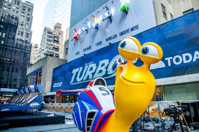 As a dramatic way to promote the new film, 20th Century Fox and DreamWorks Animation's stunt on July 9 combined oversize versions of Turbo's animated characters with Skee-Ball and a vertical race up the side of a Rockefeller Center building. The movie centers on the key character competing in the Indianapolis 500, so drivers from the high-profile car race—2013 winner Tony Kanaan and three-time champ Hélio Castroneves—were on hand, and commentator Leigh Diffey provided the play-by-play.
