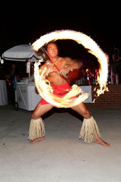 A fire dancer advanced the Hawaiian luau theme.