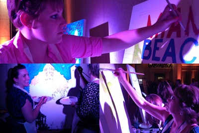 Guests paint on large pre-sketched canvases at a FUNDtech event.