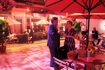 Tables with umbrellas, an enormous photo backdrop, and warm projections turned one section of Microsoft's press preview into an outdoor café. The decor for the event during Internet Week in New York also included a few potted trees and mini buckets of sunflowers.