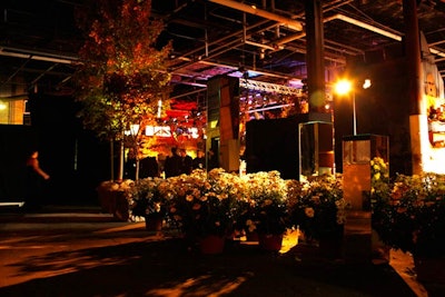 Held at an industrial site on the Hudson River, the Whitney Museum of American Art's 2011 fall gala projected warmth and intimacy through the use of live maple trees, thousands of daisies, and candlelight.