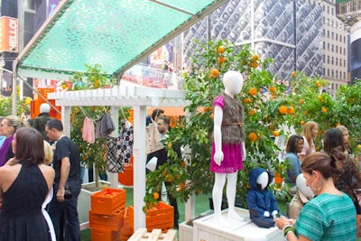 To set the scene, the production team placed dressed mannequins around orange trees, crates of the fresh fruit, and a pergola.