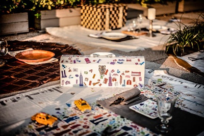 Graphic design firm Alfalfa Studio looked to the event’s location for inspiration: Toy taxi cabs accented a colorful picnic blanket that displayed an outline of Manhattan created from iconic city imagery, and a construction-worker-style lunchbox functioned as the picnic basket.