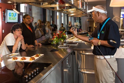 Meeting planners enjoyed light fare in the kitchens at the World of Whirlpool while golf professionals explained the basic concepts of the game.