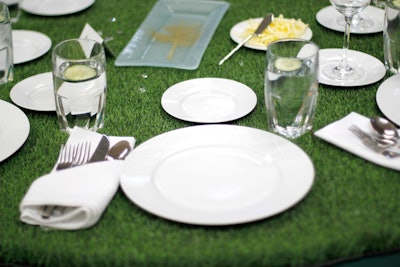 With the tagline, 'Where the grass is greener,' the March 2013 gala dinner and auction for the Georgiana Bruce Kirby Preparatory School had a garden theme. Rather than using live plants, Peggy Young & Associates covered the Santa Cruz, California, school with artificial turf, including the dining tables and the auction display where guests searched for items amidst the faux grass.