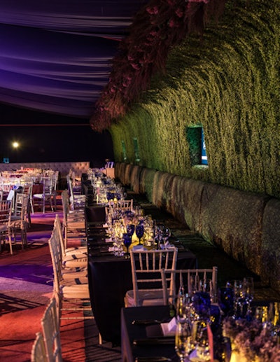 To create a lush, cocoon-like setting for the seating at the 2012 Two by Two for AIDS and Art gala and auction in Dallas, Todd Fiscus covered a banquette wall in boxwood-print slipcovers and topped it off with heather and hydrangeas.