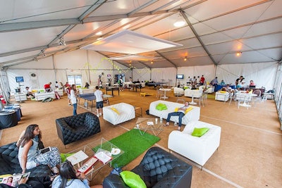 In the players' and media lounge, Design Cuisine set up multiple lounge areas mixing black and white leather sofas, chairs, and ottomans accented by neon green and yellow rugs and pillows.