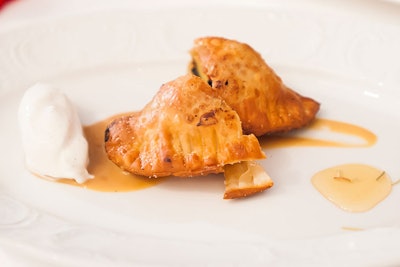 Returning champ Victor Albisu, who took the title again this year, made grilled peach empanadas with vanilla-bean ice cream and rosemary-infused honey.