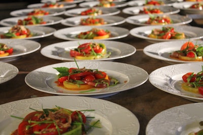 Heirloom tomatoes over a tomato reduction, capers, sweet basil pesto