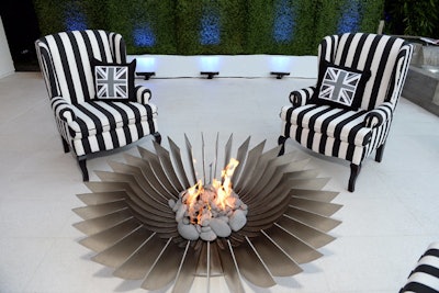 The Union Jack appeared on black and white pillows at a seating group that surrounded a modern fire pit.