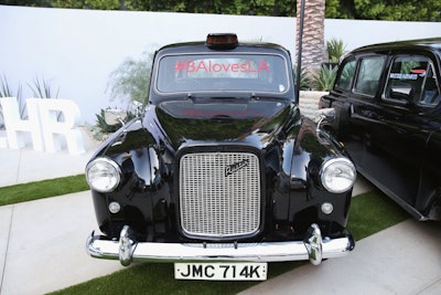 The event's official hashtag decorated the windshields of two black cars parked near the arrivals area.