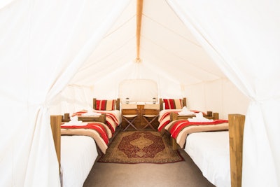 A safari tent with four twin beds perfect for groups. Photo: Jason Savage
