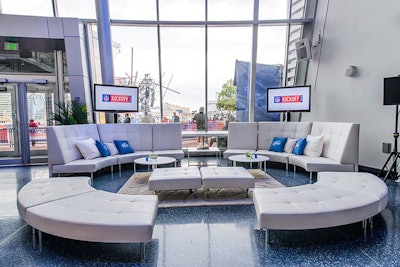 The lounge areas throughout the museum consisted of various-shaped white leather ottomans, sofas, and chairs with white and Bud Light-blue pillows.