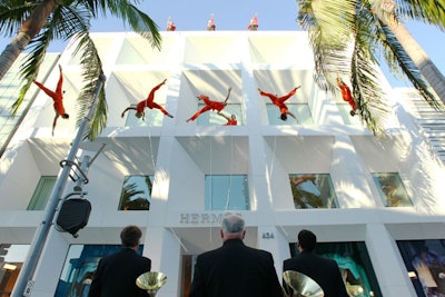 Earlier in the evening, the Bandaloop troupe of aerial dancers performed against the white marble façade of the new Beverly Hills flagship store.