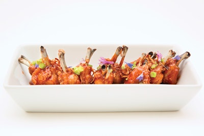 Korean-style chicken wings with scallions, fried shallots, garlic flowers, and chive flowers, by Wolfgang Puck Catering in Los Angeles