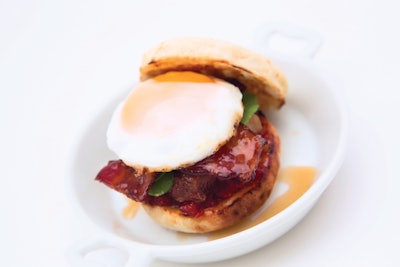 Puck muffin with maple-glazed pork, tomato jam, sorrel, and a sunny-side-up egg, by Wolfgang Puck Catering in Los Angeles