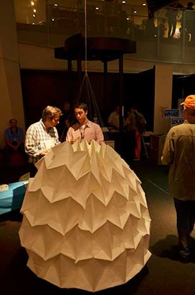 College student Jonas Lobo showed a giant interactive origami sculpture made from a single sheet of paper, which an electronic arm lifted and dropped to show it open and collapse.